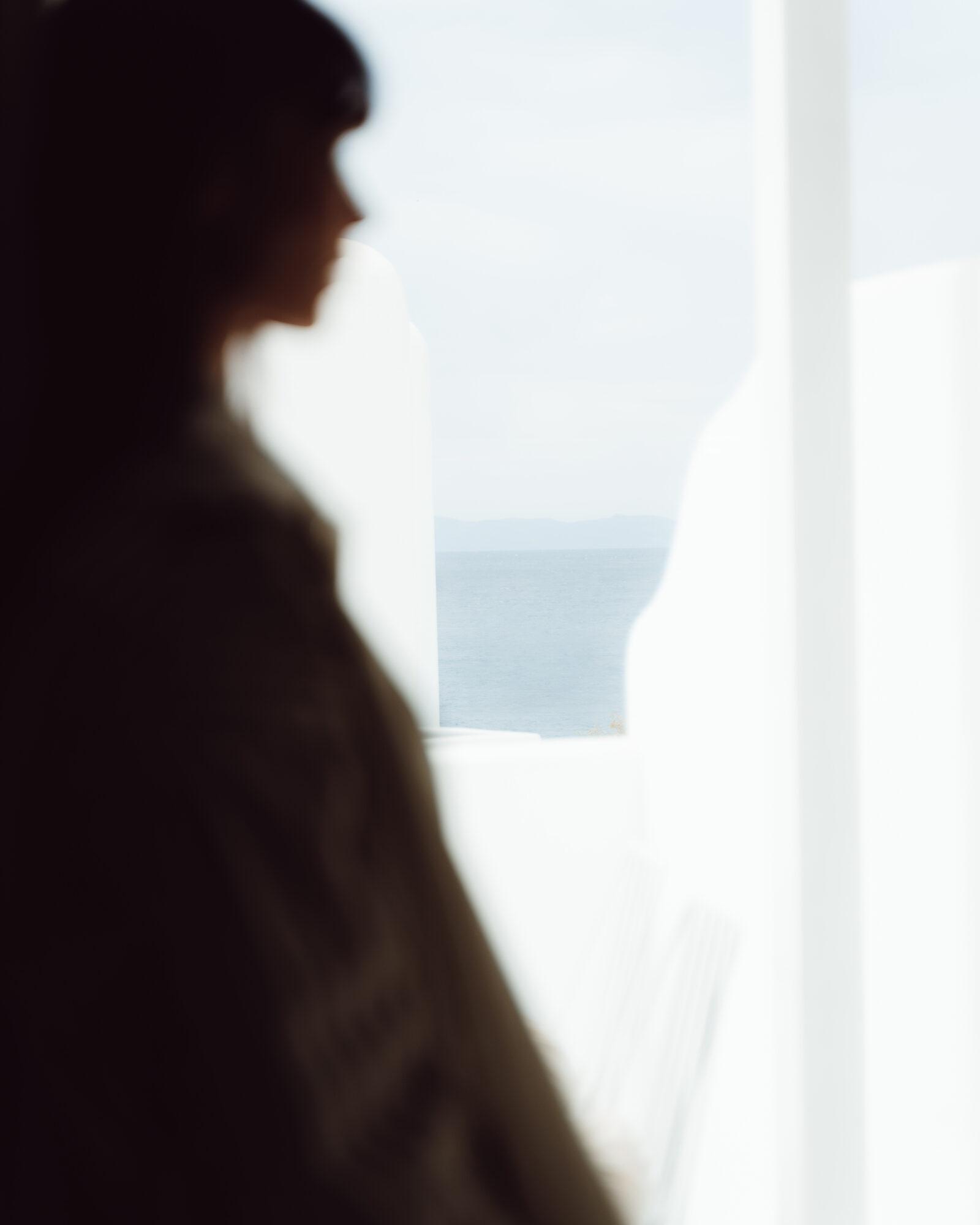 Silhouette of a woman looking out toward the sea